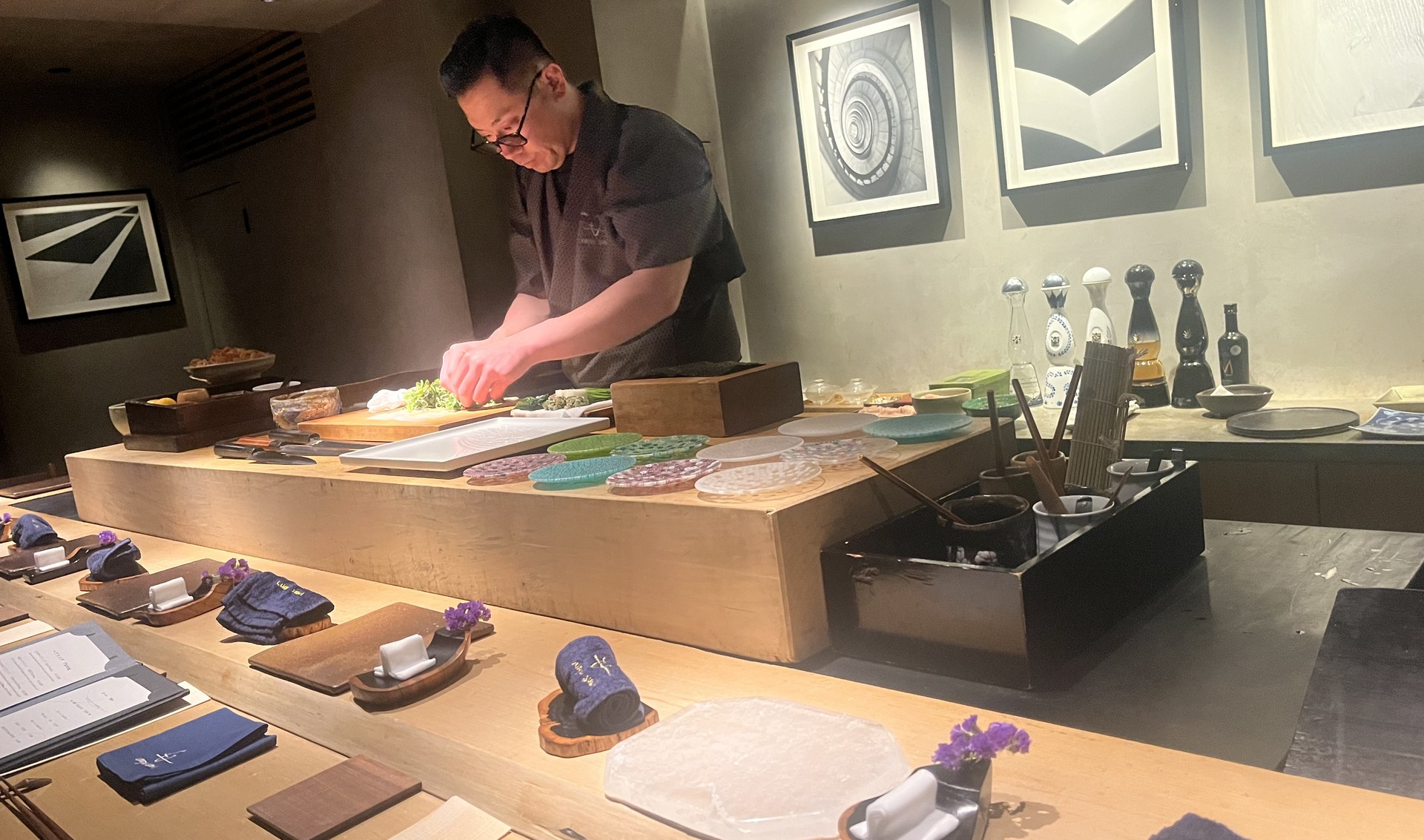 Chef preparing dishes at an omakase counter in Japan